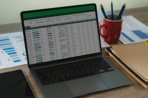 A professional analyst uses digital software and spreadsheets to present fi.. Stock Photos
