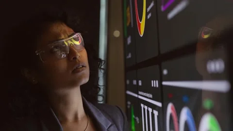 Professional analyzing a large digital dashboard with colorful charts Stock Footage 319526243
