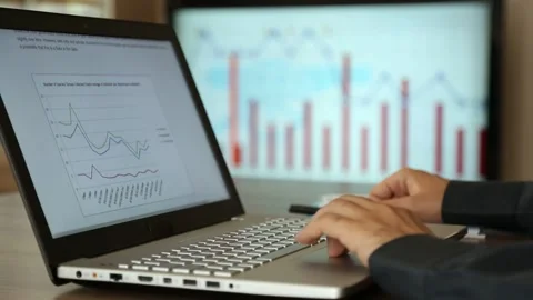Professional Analyzing Market Charts and Taking Notes Stock Footage 346180253