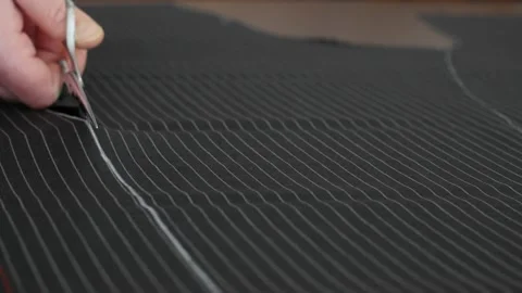 Professional and DIY Tailor work:  Close-up of young fashion designer cutting Stock Footage 138736277
