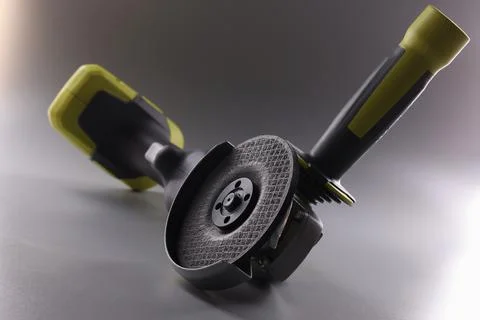 Professional angle grinder with disc on gray background Stock Photos