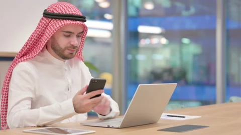 Professional Arab Businessman using Smartphone and Laptop in Office Video stock 139422170