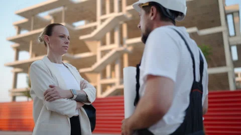 Professional architect and construction foreman discussing building bluepri.. Stock Footage 341333386