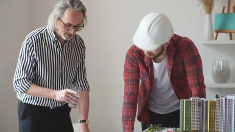 Professional architect and young student builder in office. Stock Footage 130101742