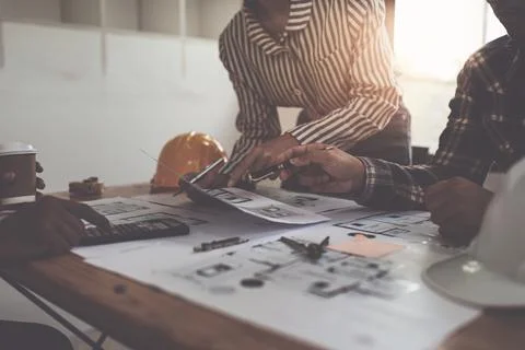 Professional architect designer structural engineer team colleagues discussing Stock Photos