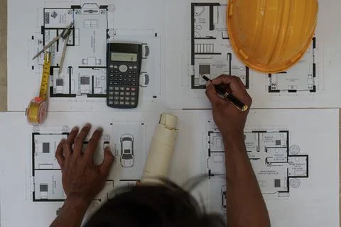 Professional architect designer structural engineer working with blueprint Fotos de archivo