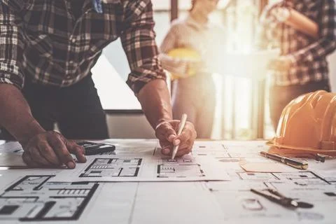 Professional architect designer structural engineer team colleagues discussing Stock Photos