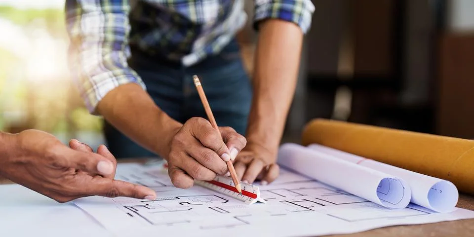Professional architect designer structural engineer team colleagues discussing Stock Photos