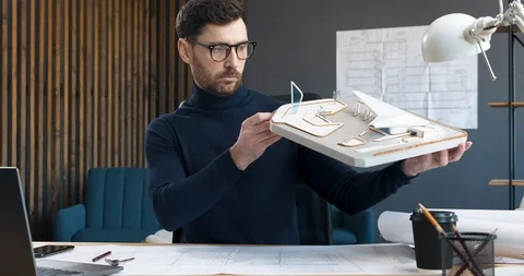 The professional Architect looks at his Layout of modern Gas Station in Office Stock-Footage 126160295