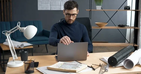 Professional Architect starting to work on Laptop in his Loft stylish Office Stock Footage 126158454