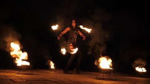 A professional artist demonstrates various fire tricks. A fire show. Stock Footage 295188975