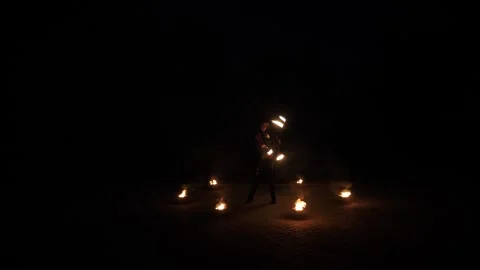 A professional artist demonstrates various fire tricks. A fire show. Stock Footage 295189197