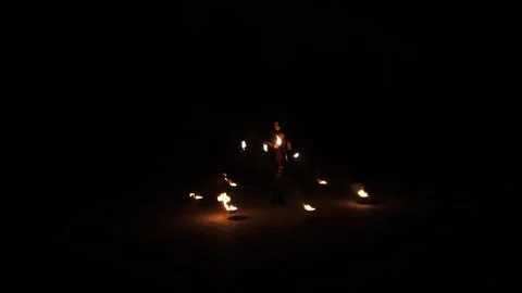 A professional artist demonstrates various fire tricks. A fire show. Stock Footage 296270333