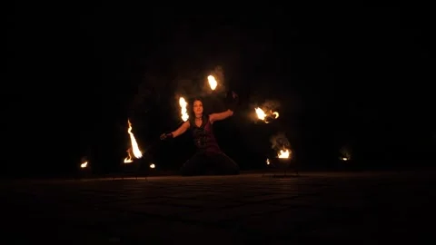A professional artist demonstrates various fire tricks. A fire show. Stock Footage 317298660