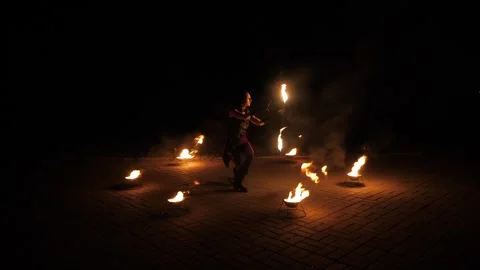 A professional artist demonstrates various fire tricks. A fire show. Stock Footage 317688042