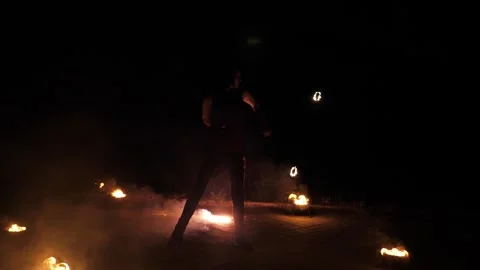 A professional artist demonstrates various fire tricks. A fire show. Stock Footage 317931658