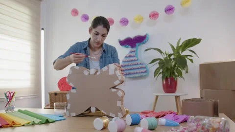 Professional artist working doing art and craft in pinatas studio Stock Footage 266729360