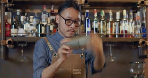 Professional Asian bartender is expertly making cocktails Video stock 219986171