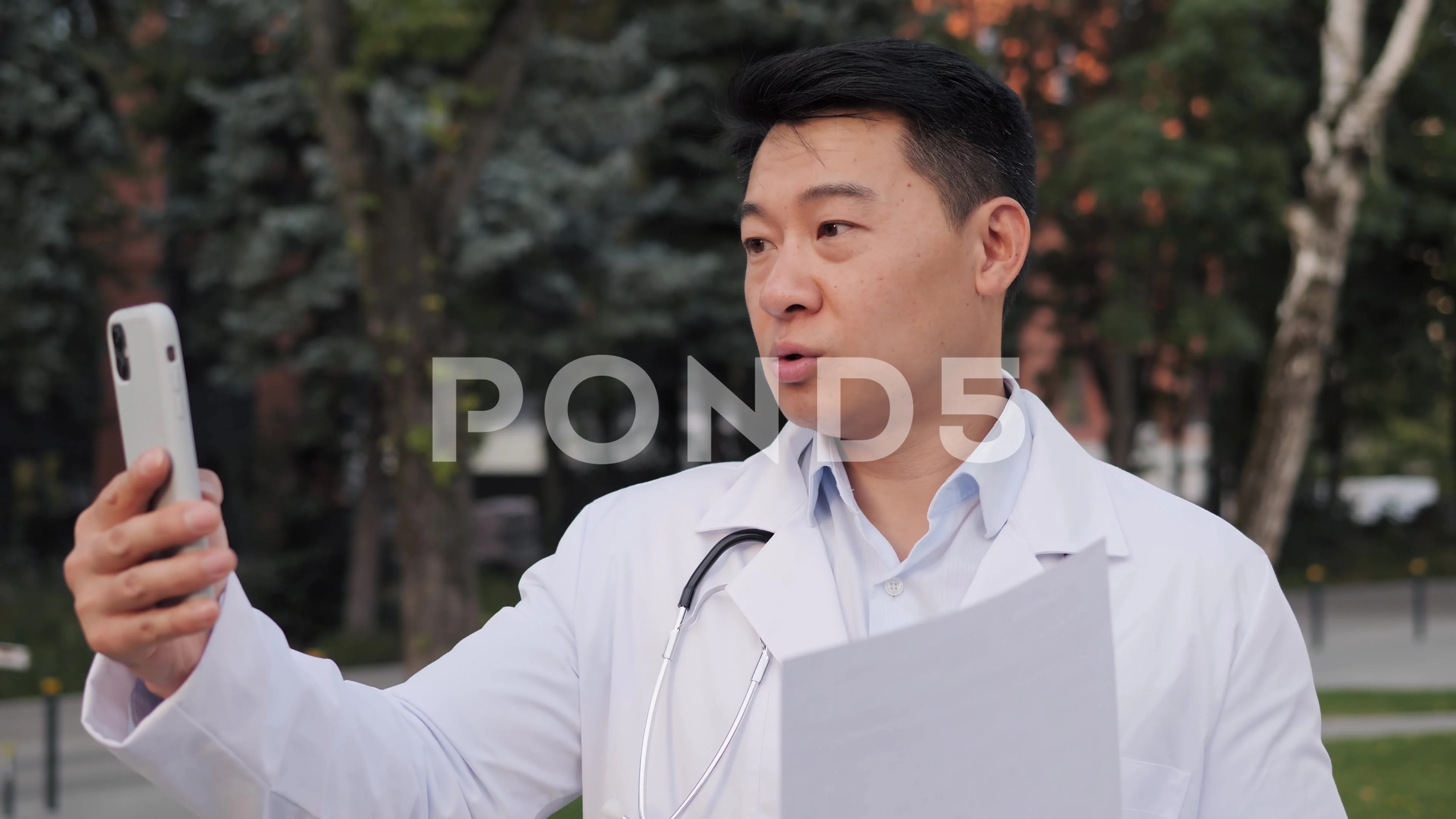 Professional asian doctor having video call with patient consulting online.