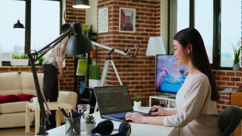 Professional asian software engineer is working remotely typing code on a laptop Stock Footage 319711756