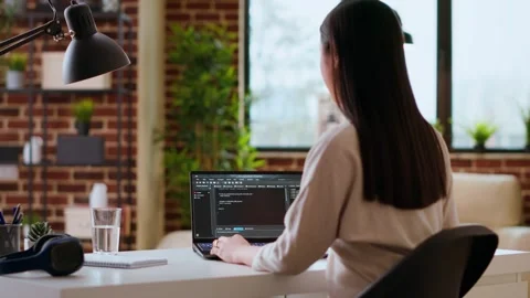 Professional asian software engineer is working remotely typing code on a laptop Stock Footage 319721892