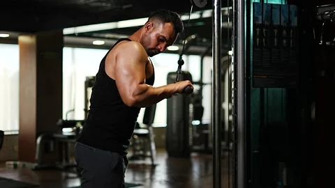 Professional athlete bodybuilder working out in the indoor gym. weight liftin Stock Footage 162655857
