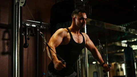 Professional athlete bodybuilder working out in the indoor gym. weight liftin Stock Footage 162655985