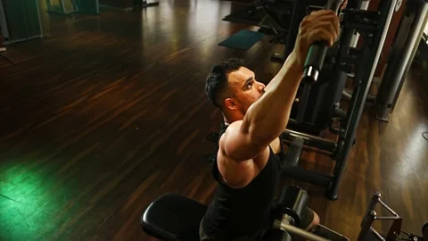 Professional athlete bodybuilder working out in the indoor gym. weight liftin Stock Footage 162656294