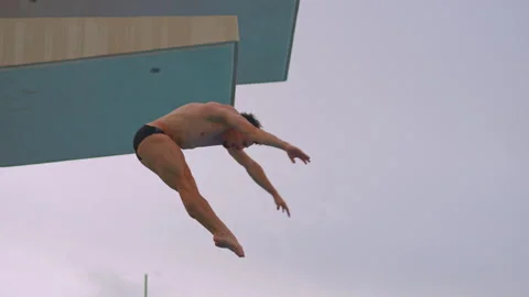 A professional athlete perfects his spring dive during training. The video Stock Footage 316507369