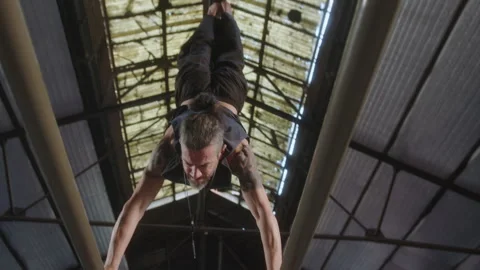 Professional Athlete Performing L-Sit and Handstand on Parallel Bars Stock-Footage 258407488