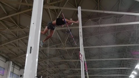 Professional athlete performing pole vaulting indoors Stock Footage 318480955