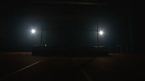 A professional athlete performs a jump over a crossbar during a high jump. Slow Stock Footage 124576395