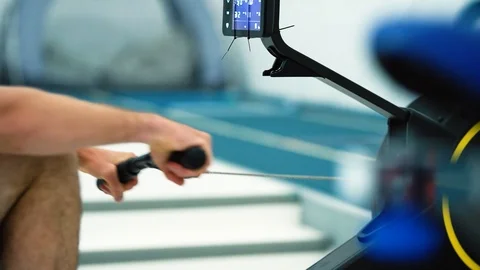 Professional athlete training on magnetic rowing machine. Man workout Video stock 123209090