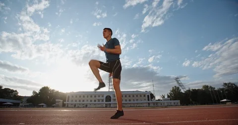 Professional athlete warming up at start of his training in morning, preparing Video stock 117538367