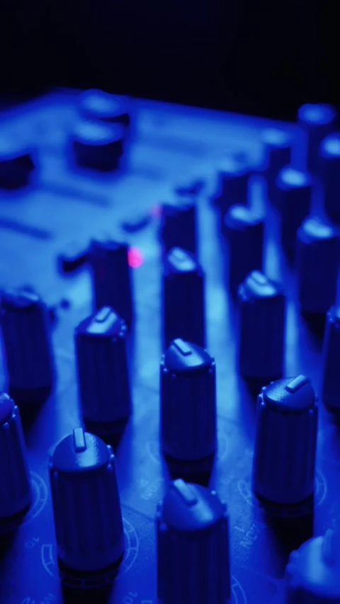 Professional Audio Mixer Knobs and Faders in Dark Music Recording Studio Stock-Footage 334739057