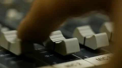 Professional audio mixing console with faders and adjusting knobs - radio Stock Footage 69919378