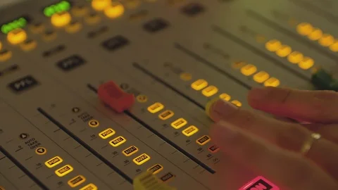 Professional audio mixing console with faders raising and lowering volume Stock Footage 114582337