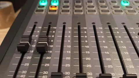 Professional Audio Mixing Console with Faders and Illuminated Buttons Stock Footage 329748578