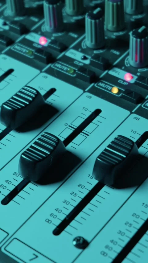 Professional Audio Mixing Console with Faders and Knobs in a Studio Setting Stock-Footage 334739309