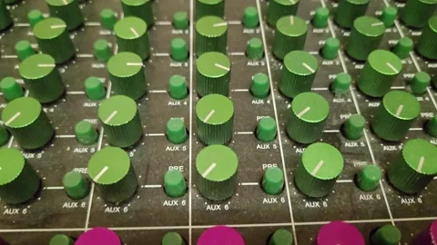 Professional audio mixing console with multiple sliders and buttons Stock Footage 320450731