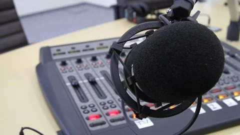 Professional audio operator working on audio mixer knobs during live TV telecast Video stock 79587349