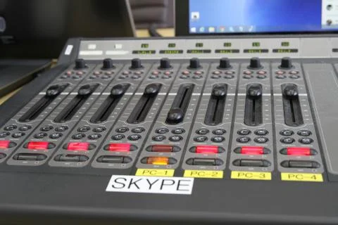 Professional audio operator working on audio mixer knobs during live TV telec Stock Photos