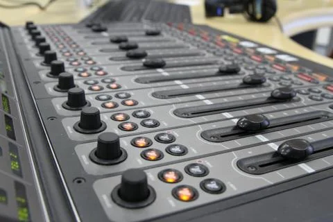 Professional audio operator working on audio mixer knobs during live TV telec Stock Photos
