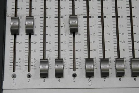 Professional audio operator working on audio mixer knobs during live TV telec Stock Photos