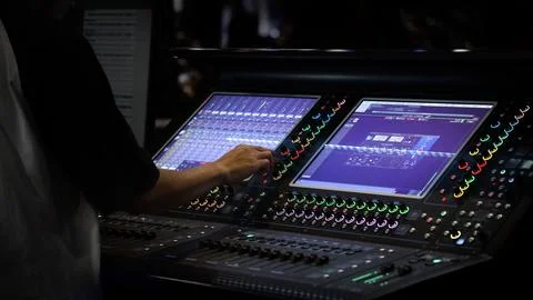 Professional audio or sound engineers operating digital mixing consoles in .. Stock Photos