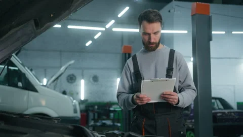 Professional auto mechanic vehicle engineer man checking car maintenance at Video stock 259659699