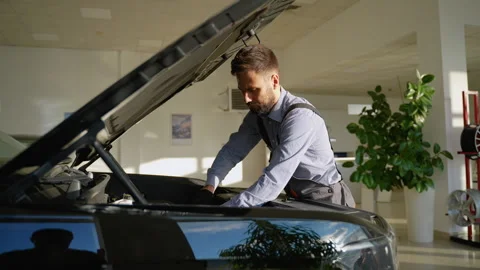 Professional auto mechanic working on car engine repair Stock Footage 300612985