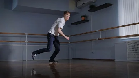 Professional b-boy in the hall for trainings. The young guy professionally Stock Footage 70367512
