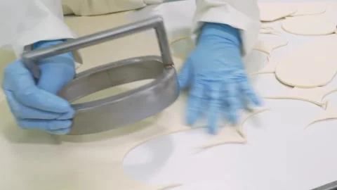 Professional Baker in Blue Gloves Cutting Round Dough Circles for Dessert Pies i Stock Footage 337751358