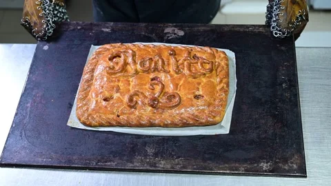 Professional baker cutting and serving a slice of galician empanada Stock-Footage 330428621